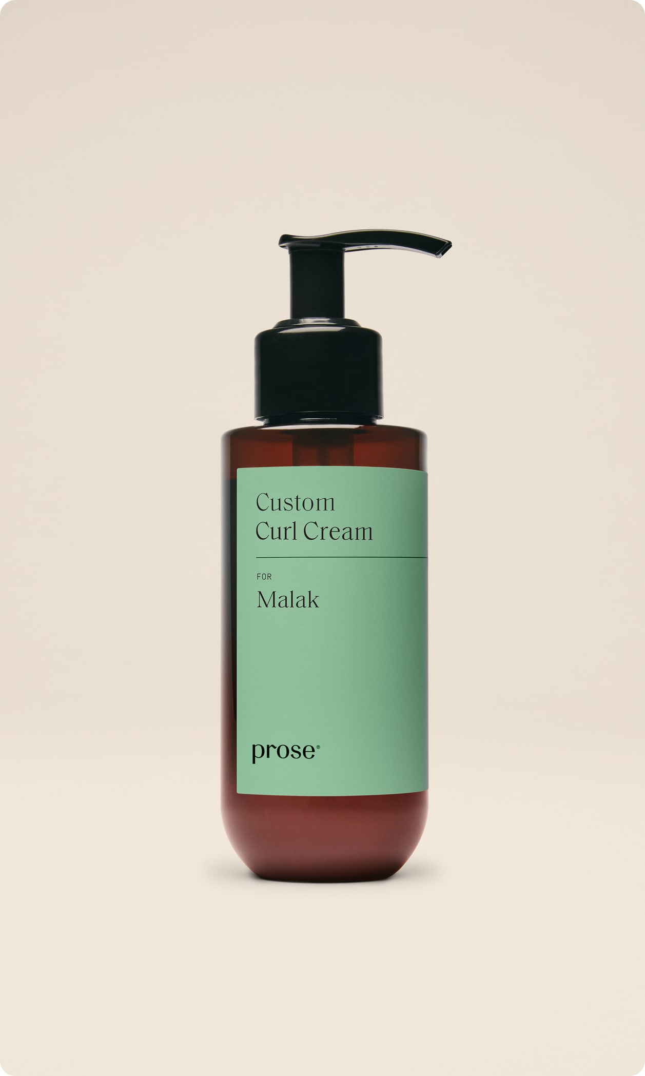 A bottle of Prose Custom Curl Cream labeled “for Malak” displayed against a neutral background.