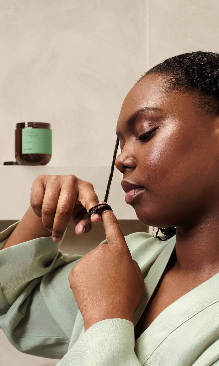 A woman styling her hair with Prose Custom Styling Gel.