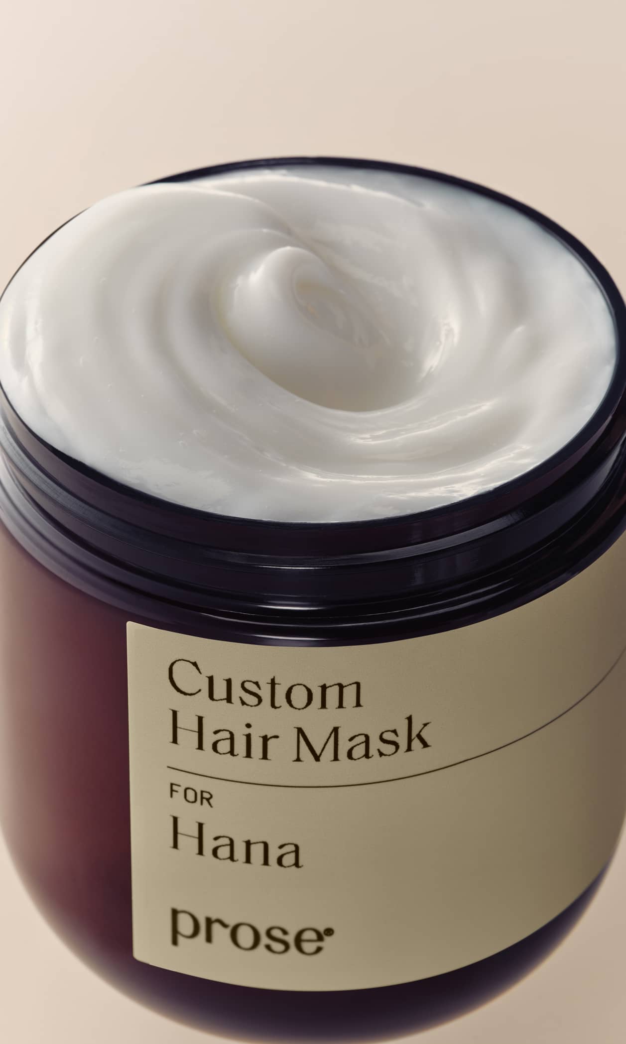 Open Prose Custom Hair Mask jar showcasing creamy texture from a top-down view.